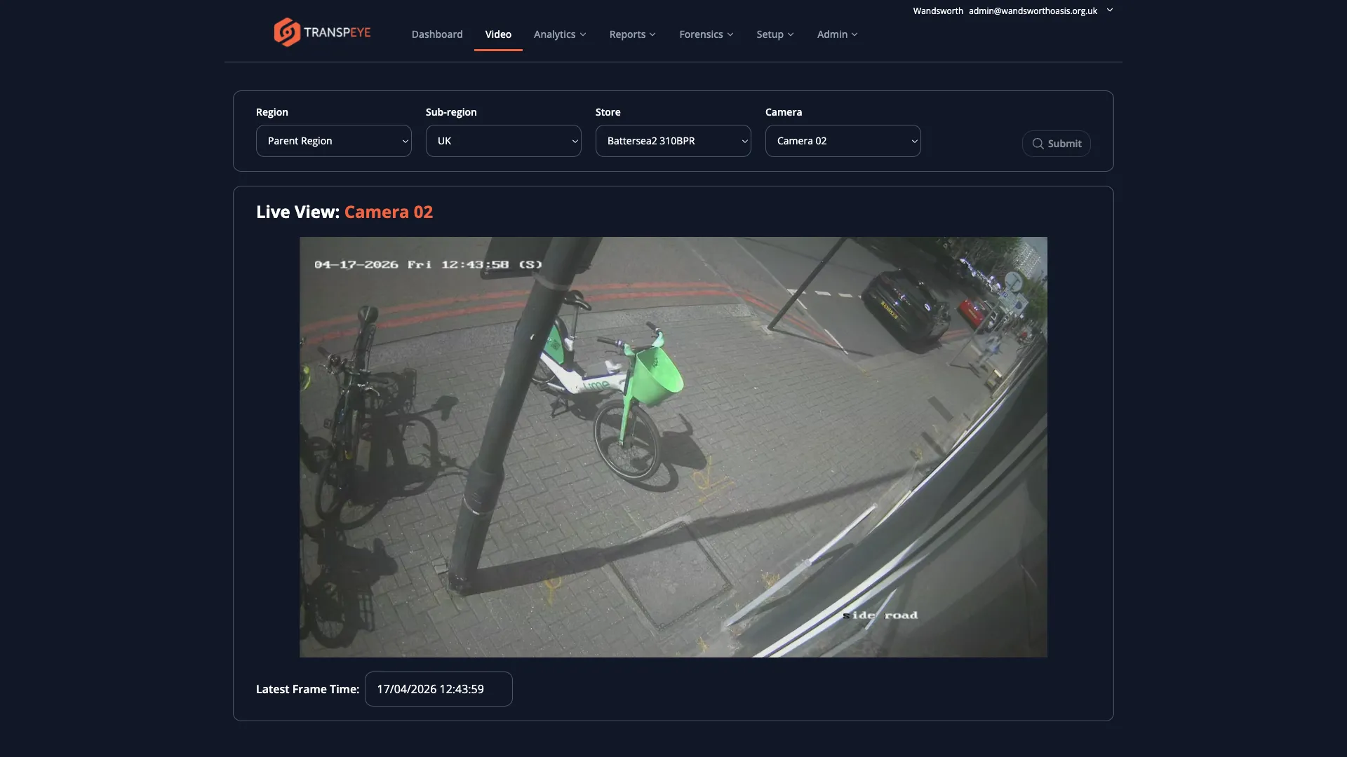 The Transpeye Live View page showing a camera feed panel on the right with a camera snapshot image, and region, sub-region, store, and camera filter dropdowns on the left allowing the user to select which camera to view